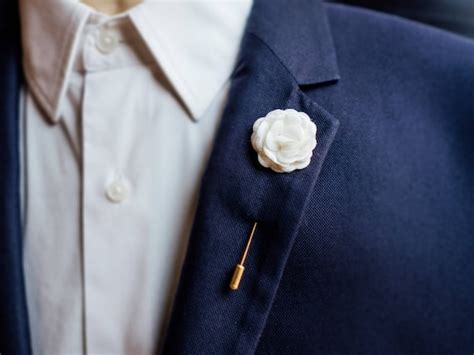 white lapel pin suit